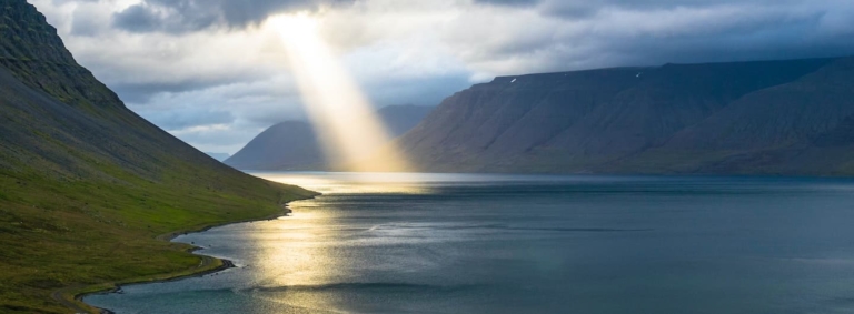 sun beam on mountain lake