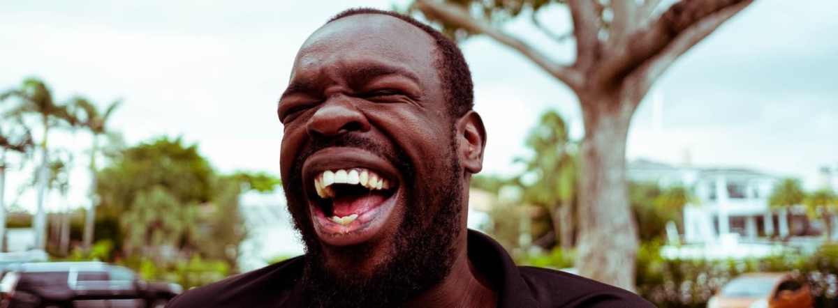 young guy laughing close up