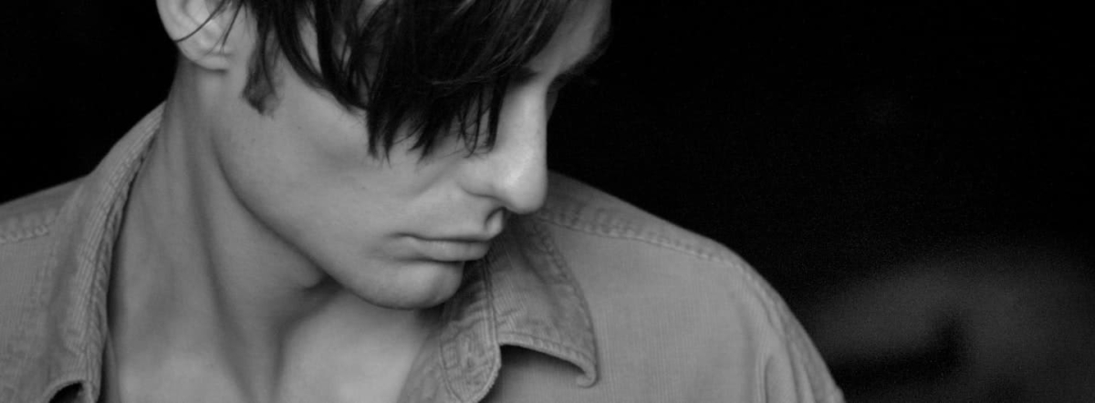 A pensive young guy in a collared shirt